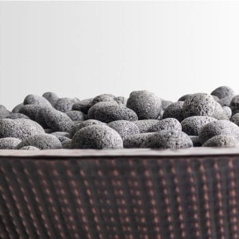 The Outdoor Plus Cazo Fire Pit - Narrow Ledge - Copper Polished Lava Rock Closeup