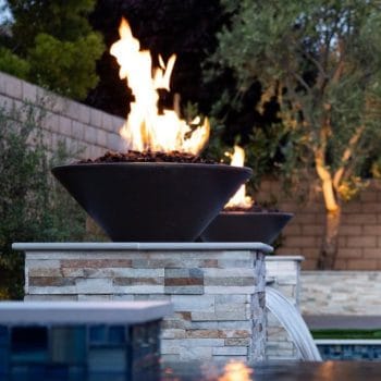The Outdoor Plus Cazo Fire Bowl - GFRC Concrete on top of stone waterfall pillars