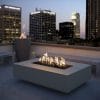 The Outdoor Plus Cabo Linear Fire Pit on a rooftop lounge
