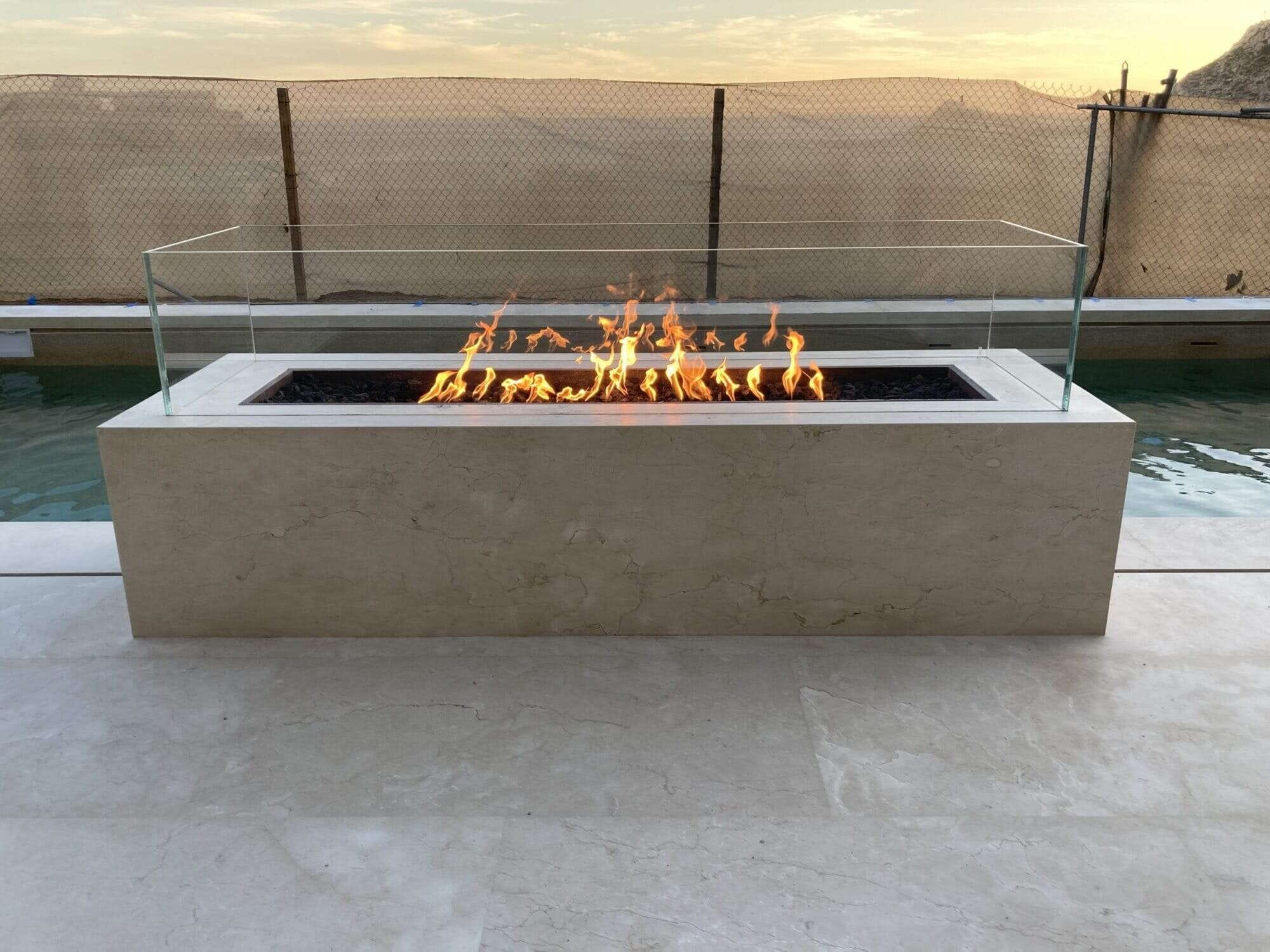 The Outdoor Plus Cabo Linear Fire Pit by the pool