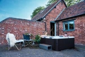 MSpa Frame Series Tribeca — Premium 6-Person Portable Hot Tub & Spa Lifestyle Photo backyard on concrete 