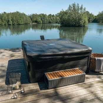MSpa Frame Series Oslo Hot tub cover and bench next to lake