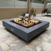 The Outdoor Plus Cabo Square Fire Pit next to Hot Tub